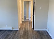 Thumbnail 36 of 43 - A hallway with wood flooring and white walls.