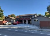 Thumbnail 9 of 36 - a house with a red car parked in a parking lot