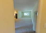 Thumbnail 20 of 22 - A room with a carpeted floor and a window.