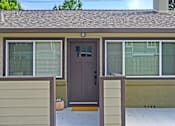 Thumbnail 20 of 27 - A house with a brown door and a brown fence.