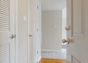 Thumbnail 31 of 37 - A white door with a gold handle is open.