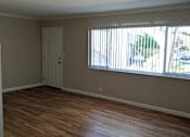 Thumbnail 38 of 42 - A room with wooden flooring and a window with blinds.