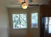 Thumbnail 20 of 26 - A room with a refrigerator and a sign that says "Now Leasing".