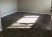Thumbnail 30 of 31 - an empty living room with the sun shining through the window