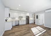 Thumbnail 53 of 67 - A kitchen with white cabinets and a wooden floor.