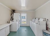 Thumbnail 41 of 43 - A laundry room with a washer and dryer in it.
