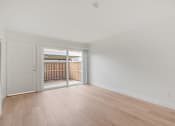 Thumbnail 41 of 51 - A room with a white door and wooden flooring.
