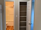 Thumbnail 23 of 42 - A white door is open to a room with a toilet and shelves.