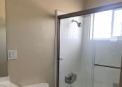 Thumbnail 25 of 31 - a bathroom with a toilet and a shower