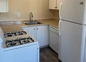 Thumbnail 29 of 33 - A white fridge and stove in a kitchen.