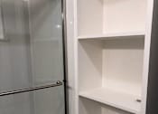 Thumbnail 47 of 47 - A white shelving unit with a glass door.
