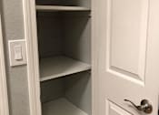 Thumbnail 30 of 47 - A white door with a silver handle and a white light switch on the wall.
