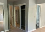 Thumbnail 17 of 22 - A room with a ceiling fan and a carpeted floor.