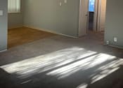 Thumbnail 34 of 37 - A room with a ceiling fan and a door leading to another room.