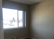 Thumbnail 15 of 31 - an empty room with a large window and carpet