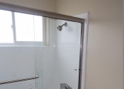 Thumbnail 22 of 31 - a white bathroom with a shower and a toilet
