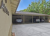 Thumbnail 8 of 47 - A carport with three cars parked in it.