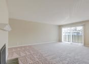 Thumbnail 30 of 37 - A room with a carpeted floor and a window with blinds.