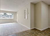 Thumbnail 26 of 33 - an empty room with a window and tile floor