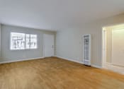 Thumbnail 9 of 38 - A room with wooden flooring and two doors.
