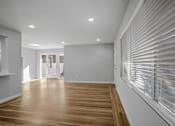 Thumbnail 7 of 31 - A room with wooden floors and white walls.