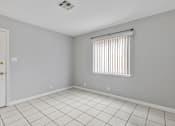 Thumbnail 36 of 38 - A room with a white tile floor and a window with blinds.