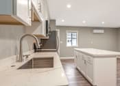 Thumbnail 51 of 62 - A modern kitchen with a marble countertop and stainless steel appliances.