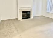 Thumbnail 4 of 26 - the living room of an empty house with a fireplace