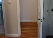 Thumbnail 28 of 42 - A white door is open to a hallway.