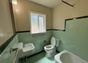 Thumbnail 15 of 19 - a bathroom with a toilet and a sink and a tub