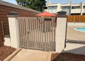 Thumbnail 37 of 37 - a fence with a red umbrella in front of a pool