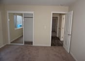 Thumbnail 15 of 22 - A room with a carpeted floor and white walls.