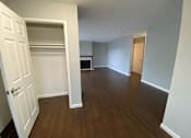 Thumbnail 33 of 41 - an empty living room with wood flooring and a closet