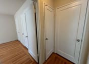 Thumbnail 16 of 19 - a bedroom with three closets and a hard wood floor
