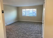 Thumbnail 13 of 43 - A room with a window and carpeted floor.