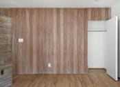 Thumbnail 30 of 33 - A room with a wooden wall and a white door.
