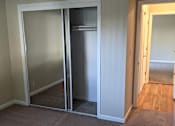 Thumbnail 32 of 42 - A room with a carpeted floor and a white door.
