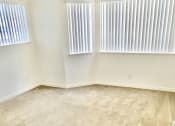 Thumbnail 1 of 26 - an empty room with two windows and a carpeted floor