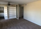 Thumbnail 31 of 31 - an empty room with a closet and a ceiling fan