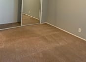 Thumbnail 36 of 37 - A room with a carpeted floor and a sliding glass door.