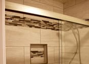 Thumbnail 2 of 22 - a bathroom with a shower with a glass door