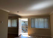 Thumbnail 10 of 62 - an empty living room with a door to a balcony