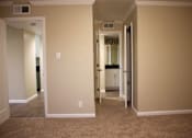Thumbnail 3 of 22 - a room with a carpeted floor and a hallway with a closet and a bathroom