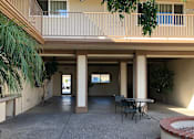 Thumbnail 15 of 62 - a courtyard with a table and chairs outside of a building