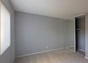 Thumbnail 19 of 23 - an empty living room with a mirrored closet door