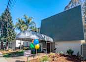 Thumbnail 2 of 23 - a building with an umbrella and balloons in front of it