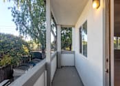 Thumbnail 22 of 23 - the front porch of a home with a large window and a bench
