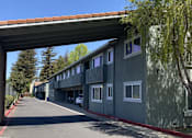Thumbnail 1 of 43 - A row of houses under a bridge on a sunny day.