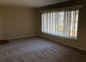 Thumbnail 19 of 31 - an empty living room with a large window