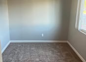 Thumbnail 5 of 14 - an empty room with a carpet and two windows